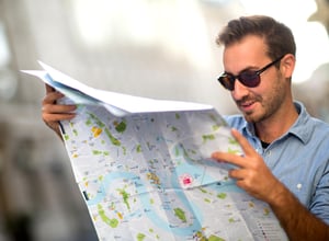 Man looking lost and holding a map