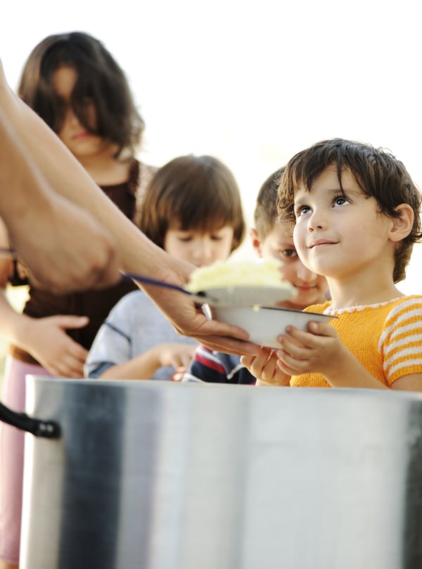 Hungry children in refugee camp, distribution of humanitarian food